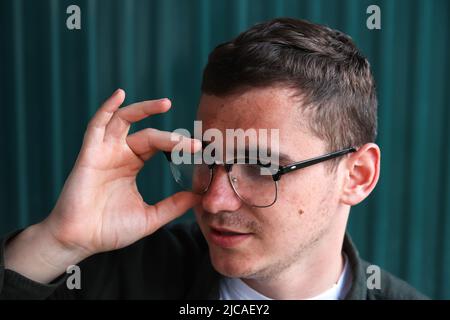 Man wearing eyeglasses. Happy smiling smart man. Portrait of handsome smiling stylish hipster lambersexual model. Male on the modern background. Styli Stock Photo