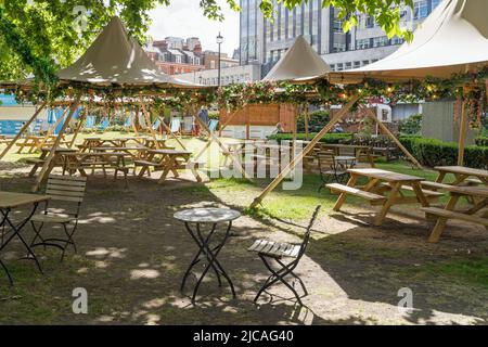 Cavendish Square with tables and chairs set up outside in the summer sun under gazebos. London Stock Photo