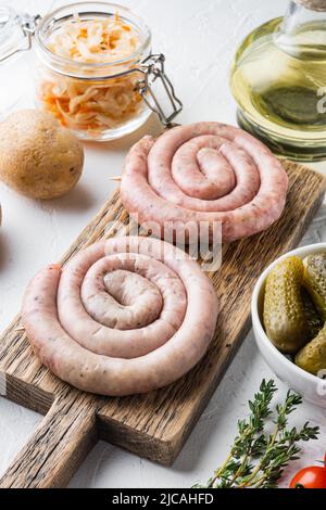 Fried Bavarian German Nürnberger sausages with sauerkraut, mashed potatoes, on white background Stock Photo