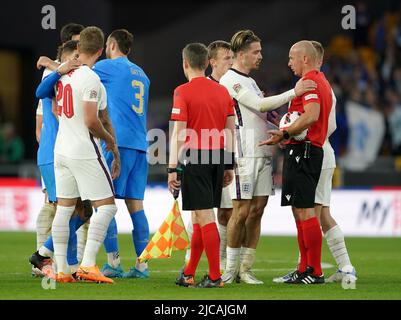 England's Jack Grealish speaks with referee Szymon Marciniak after the final whistle during the UEFA Nations League match at the Molineux Stadium, Wolverhampton. Picture date: Saturday June 11, 2022. Stock Photo