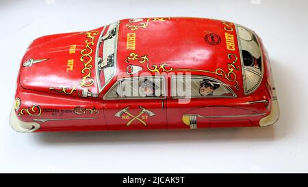 Collectible antique red tin litho fire chief car on white background Stock Photo