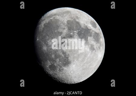 London, UK.  11 June 2022. UK Weather : A 90% waxing gibbous moon is seen in a clear, early evening sky over north west London.  This month’s upcoming full moon, known as a Strawberry Moon, will also be a supermoon as it will be closest to the Earth during its orbit.  During a supermoon, the moon can appear up to 14 per cent bigger and 30 per cent brighter compared with when it is furthest away.  Credit: Stephen Chung / Alamy Live News Stock Photo