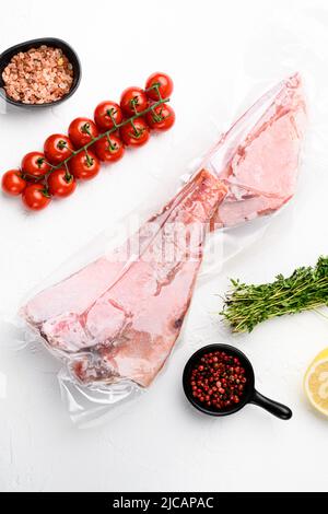 Red Snapper frozen pack fish meat set, with herbs, on white stone table ...