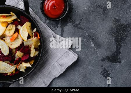 Dried vegetables chips, on gray stone table background, top view flat lay, with copy space for text Stock Photo