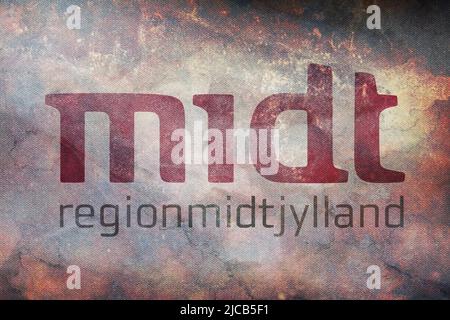 Top view of retro flag Region Midtjylland, Denmark with grunge texture. Danish travel and patriot concept. no flagpole. Plane layout, design. Flag bac Stock Photo