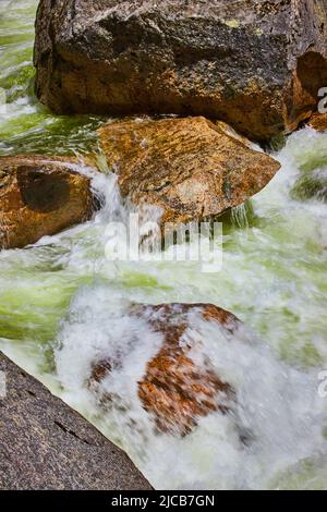 River with sharp piece of rock and water cascading over top Stock Photo