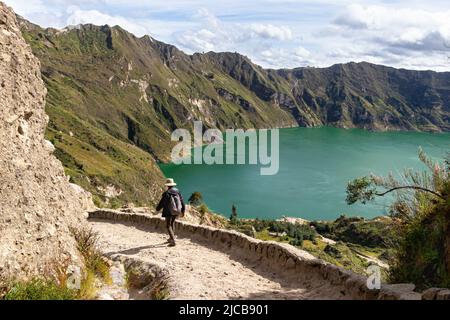 Lake Quilotoa in caldera of eponymous volcano Quilotoa.  Hiking patch and tourist on the way down to the lake. Cotopaxi province, Ecuador Stock Photo