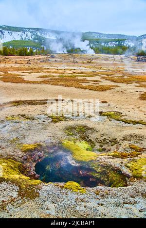 Steamy hole in Yellowstone basin during winter Stock Photo