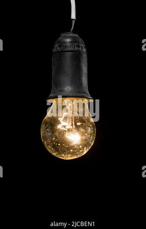 retro shining light bulb on a black background Stock Photo