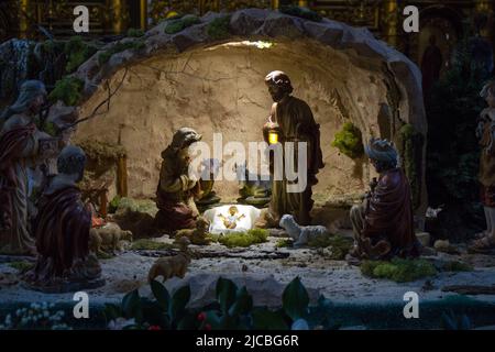 Christmas Manger scene with figurines including Jesus, Mary, Joseph, sheep and magi. Stock Photo