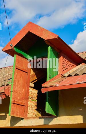 open door to the attic in an old house for storing hay Stock Photo