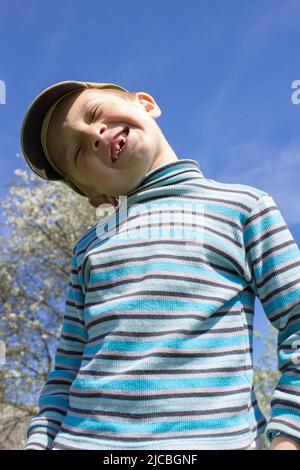 Smiling boy without front teeth, outdoors in the spring Stock Photo