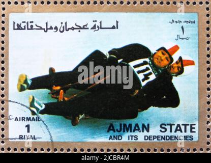 AJMAN - CIRCA 1973: a stamp printed in the Ajman shows Two-man Sledge, Winter Olympics, circa 1973 Stock Photo