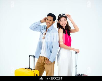 Couple travelers ready to trip in happy holiday. Colorful summer vacation. Young beauty Asian woman and handsome man in casual costume standing togeth Stock Photo