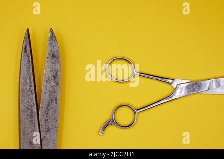 Old scissors on a yellow background Stock Photo