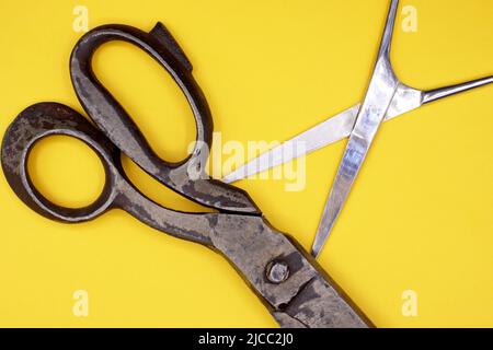 Old scissors on a yellow background Stock Photo