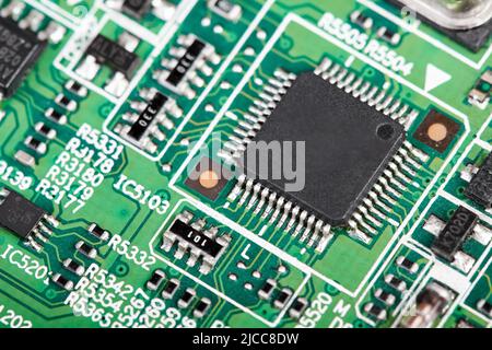 Close-up of a green computer printed circuit board with selective focus on a chip Stock Photo