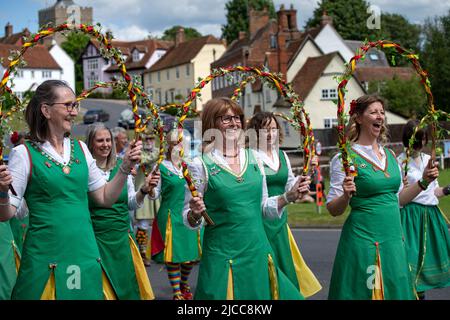 Thaxted, Essex, UK. 11th June 2022.  Chelmsford Ladies one of the few all female Morris sides seen here performing in Finchingfield Essex, performing ‘May the Fours' writen by the team. Fourteen Morris Dancing sides danced through 14 villages in north west Essex for the first time since Covid restrictions were lifted for the Thaxted Morris Weekend. The Credit: BRIAN HARRIS/Alamy Live News Stock Photo