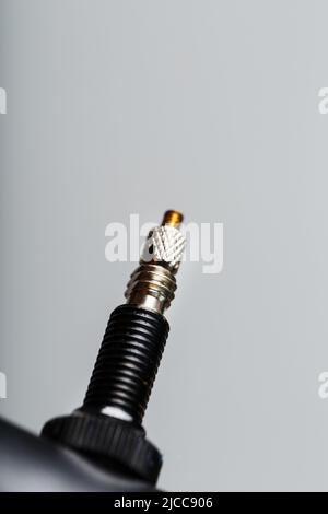 Nipple on bicycle rim for tubeless system close-up on gray background Stock Photo