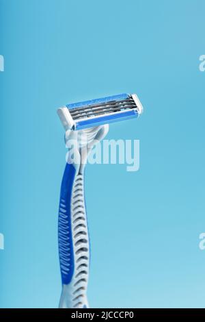 Blades of a new shaving machine on a blue background close-up free space Stock Photo