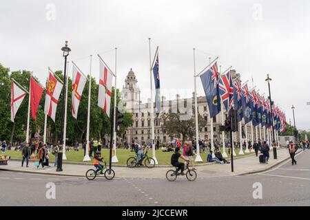 national flags of common wealth countries flapping in the wind in Parliament square during the Queen's platinum jubilee weekend celebration England UK Stock Photo