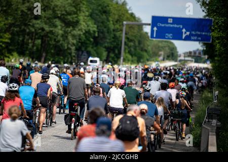 Berlin, Germany. 12th June, 2022. Participants in the ADFC Sternfahrt ride along the Avus section of the A115 autobahn, which is closed to cars. Since the morning, cyclists from the outskirts of the city and from Brandenburg have been riding on 18 routes to the Großer Stern in downtown Berlin. The ADFC demands the implementation of the bicycle traffic plan. Credit: Fabian Sommer/dpa/Alamy Live News Stock Photo
