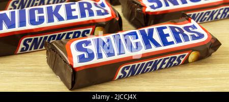 Hamburg, Germany - June 8  2022:  5 Chocolate bars Snickers on wooden background Stock Photo