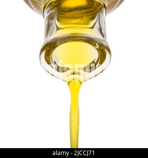 Oil pouring from a bottle. Isolated on white. Stock Photo
