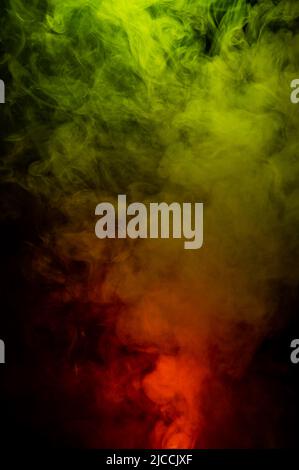 Red-yellow smoke spreads on a black background Stock Photo - Alamy