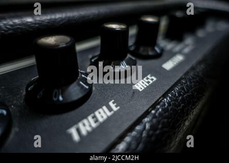 A top of a black guitar amplifier. treble, bass knobs. India Stock Photo