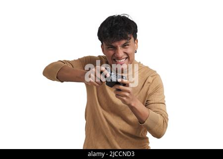 Young peruvian man playing video games with a joystick, isolated. Stock Photo