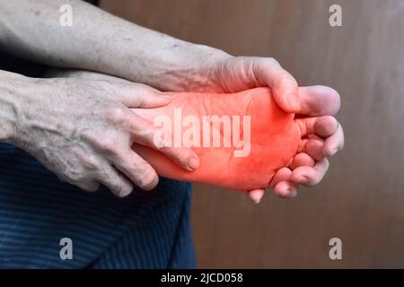 Tingling and burning sensation in foot of Asian old man with diabetes. Foot pain. Sensory neuropathy problems. Foot nerves problems. Plantar fasciitis Stock Photo