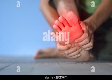 Tingling and burning sensation in foot of Asian young man with diabetes. Toes pain. Sensory neuropathy problems. Foot nerves problems. Plantar fasciit Stock Photo