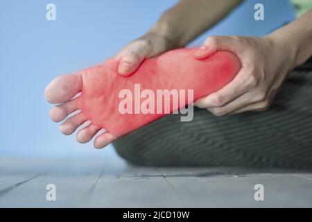 Tingling and burning sensation in foot of Asian young man with diabetes. Foot pain. Sensory neuropathy problems. Foot nerves problems. Plantar fasciit Stock Photo