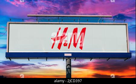 POZNAN, POL - MAY 1, 2022: Advertisement billboard displaying logo of Hennes & Mauritz, a Swedish multinational clothing-retail company Stock Photo