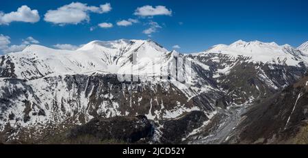 Panoramic view of snow covered peaks of the Greater Caucasus Mountains. Republic of Georgia. Stock Photo