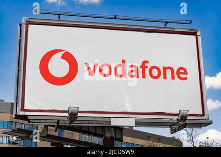 POZNAN, POL - MAY 1, 2022: Advertisement billboard displaying logo of Vodafone Group,  a British multinational telecommunications company Stock Photo