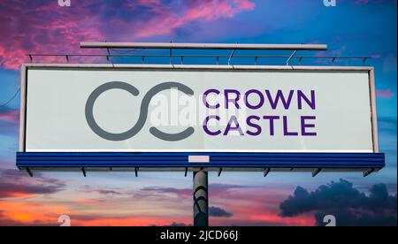 POZNAN, POL - MAY 1, 2022: Advertisement billboard displaying logo of Crown Castle, a real estate investment trust and provider of shared communicatio Stock Photo