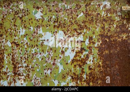 Layers of peeling paint texture on weathered rusty metal sheet, grunge background Stock Photo