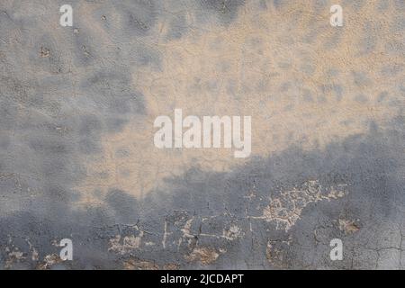 Plastered wall with damp stain and peeling paint, urban grungy background Stock Photo