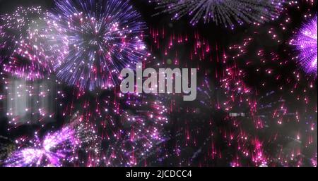 Image of exploded pink and red fireworks in night sky Stock Photo