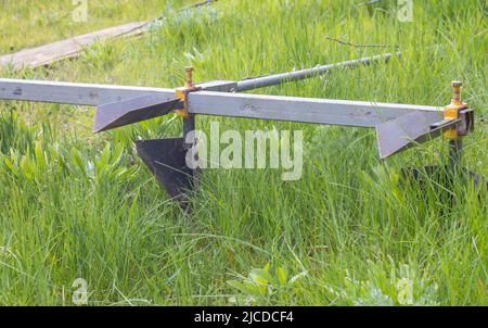 Agricultural manual metal plow on the field. Plowing the land before sowing. Close-up. Inventory for plowing potatoes in the countryside. A plow is a Stock Photo