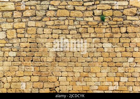 background, texture - a wall of rough blocks, with cracks between stones Stock Photo