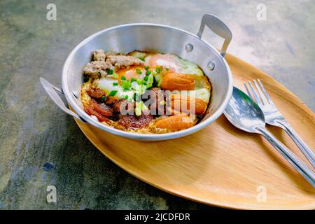 fried egg with tomato bacon in pan breakfast morning business food still life Stock Photo