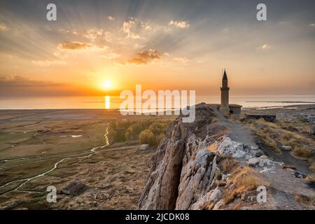 Sunset over the Van castle and Van lake with a minaret. Stock Photo