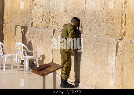 Jerusalem, Israel, 15 April, 2022: Israeli soldier praying in front of Sacred Western Wall in Jerusalem Old City Jewish Temple Stock Photo