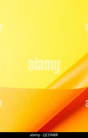 Abstract wave of yellow and orange paper. Creative geometric curved paper with light and shadows. Abstract geometry background with copy space Stock Photo