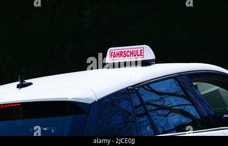 Berlin, Germany. 28th Mar, 2022. 28.03.2022, Berlin. A sign reading 'Fahrschule' (driving school) is placed on the roof of a driving school car. Credit: Wolfram Steinberg/dpa Credit: Wolfram Steinberg/dpa/Alamy Live News Stock Photo