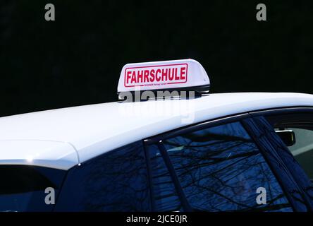 Berlin, Germany. 28th Mar, 2022. 28.03.2022, Berlin. A sign reading 'Fahrschule' (driving school) is placed on the roof of a driving school car. Credit: Wolfram Steinberg/dpa Credit: Wolfram Steinberg/dpa/Alamy Live News Stock Photo