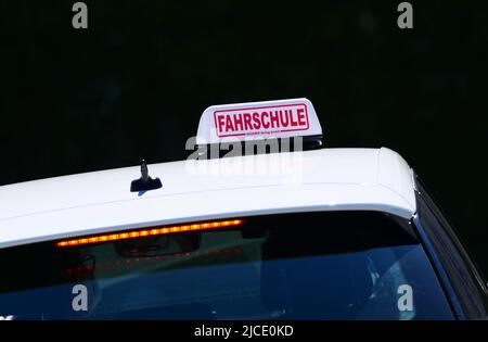 Berlin, Germany. 28th Mar, 2022. 28.03.2022, Berlin. A sign reading 'Fahrschule' (driving school) is placed on the roof of a driving school car. Credit: Wolfram Steinberg/dpa Credit: Wolfram Steinberg/dpa/Alamy Live News Stock Photo